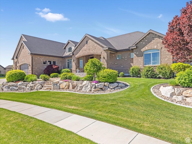 14738 S Currant Creek Cir W, Bluffdale, UT 84065 - view of front of property featuring brick siding, a front yard, and a shingled roof