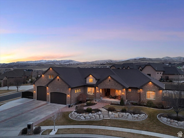 14738 S Currant Creek Cir W, Bluffdale, UT 84065 - view of front facade featuring a mountain view, concrete driveway, an attached garage, and brick siding