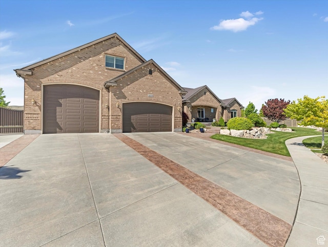 14738 S Currant Creek Cir W, Bluffdale, UT 84065 - view of front of house featuring brick siding, driveway, and an attached garage