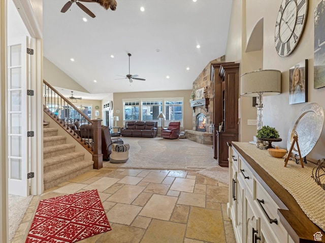14738 S Currant Creek Cir W, Bluffdale, UT 84065 - entrance foyer featuring ceiling fan, stairway, high vaulted ceiling, stone tile floors, and a fireplace