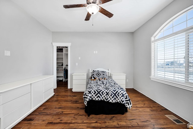 living area featuring ceiling fan, visible vents, and wood finished floors