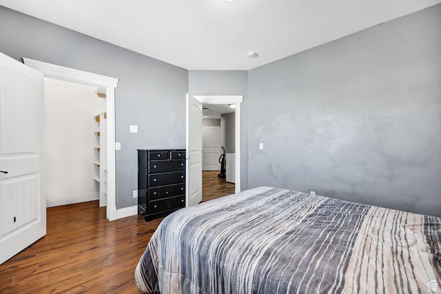 bedroom featuring wood finished floors and baseboards