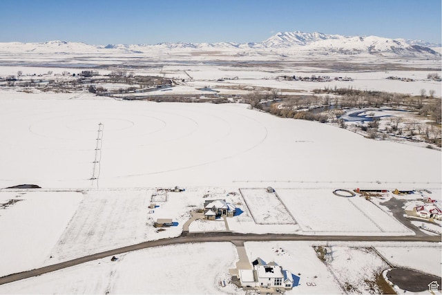 snowy aerial view with a mountain view