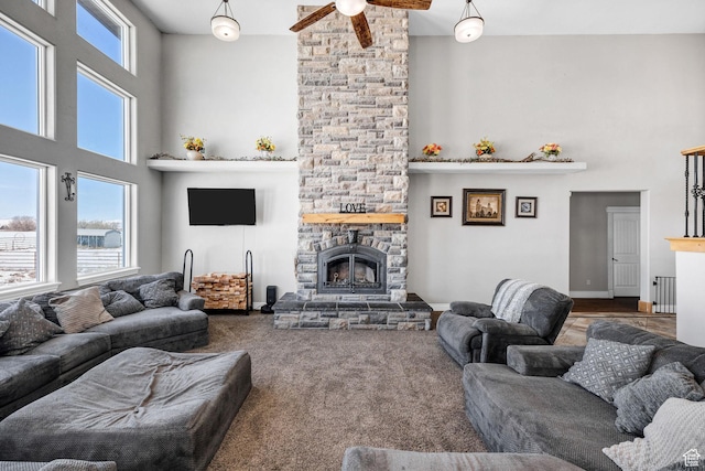 living room with a fireplace, radiator heating unit, carpet, and a towering ceiling