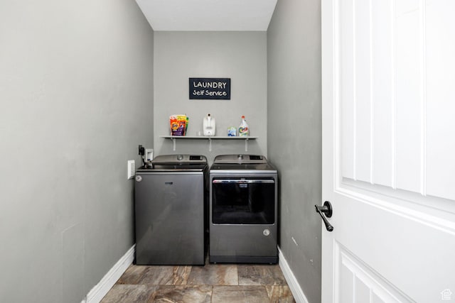 laundry area featuring washer and dryer, laundry area, and baseboards