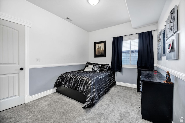 bedroom with visible vents, baseboards, and carpet