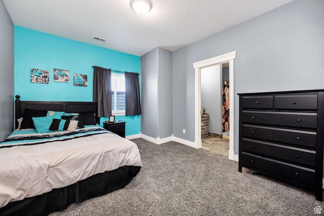 carpeted bedroom with visible vents and baseboards