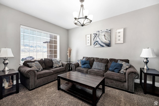 living area featuring baseboards and a notable chandelier