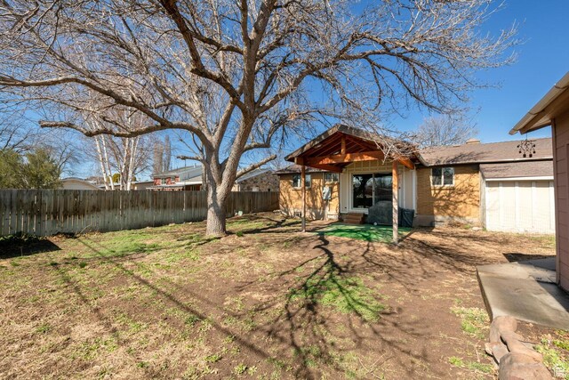 view of yard featuring a garage and fence