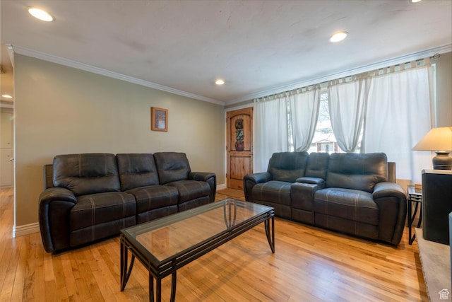 living area featuring light wood finished floors, crown molding, and baseboards