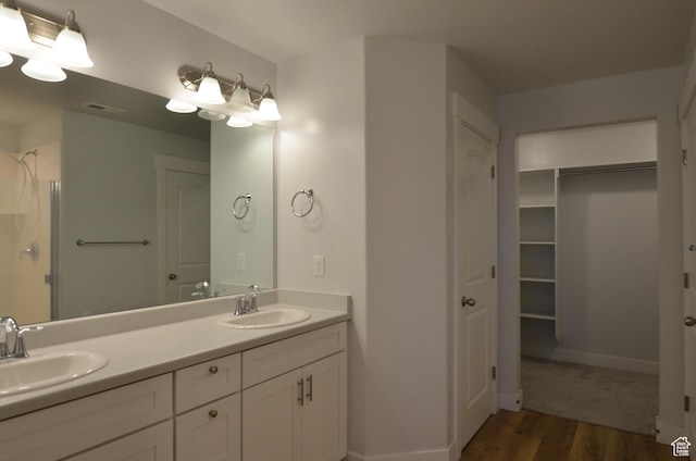 5289 W Van Dyne Ln, Herriman, UT 84096 - full bath with double vanity, a shower, wood finished floors, and a sink