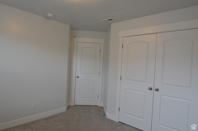 5289 W Van Dyne Ln, Herriman, UT 84096 - unfurnished bedroom featuring a closet, visible vents, light colored carpet, and baseboards