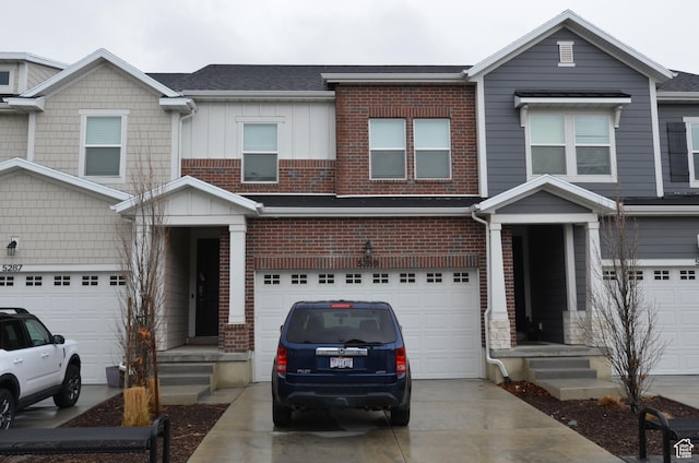 5289 W Van Dyne Ln, Herriman, UT 84096 - townhome / multi-family property featuring an attached garage, brick siding, board and batten siding, and driveway
