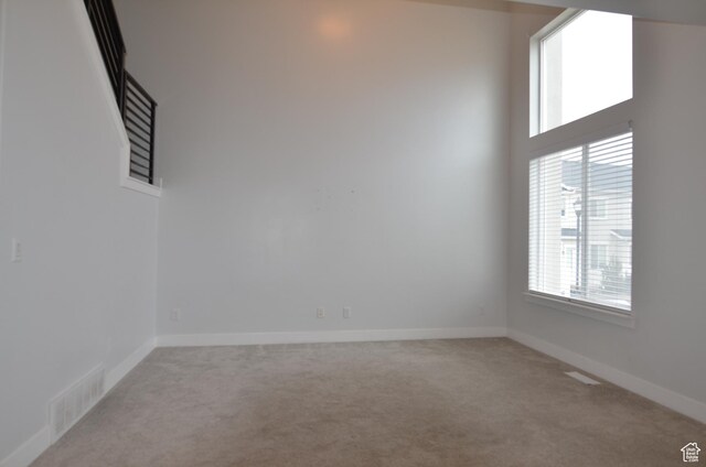 5289 W Van Dyne Ln, Herriman, UT 84096 - spare room with a high ceiling, baseboards, visible vents, and light carpet