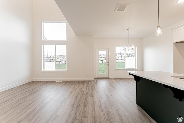 642 W 4500 S Unit 322, Mapleton, UT 84664 - unfurnished dining area with healthy amount of natural light, light wood-style floors, and a chandelier