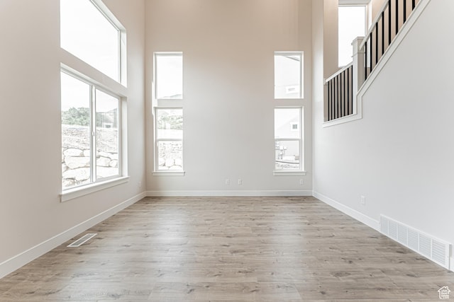 624 W 4500 S Unit 325, Mapleton, UT 84664 - unfurnished room featuring a towering ceiling, light wood-type flooring, and stairs