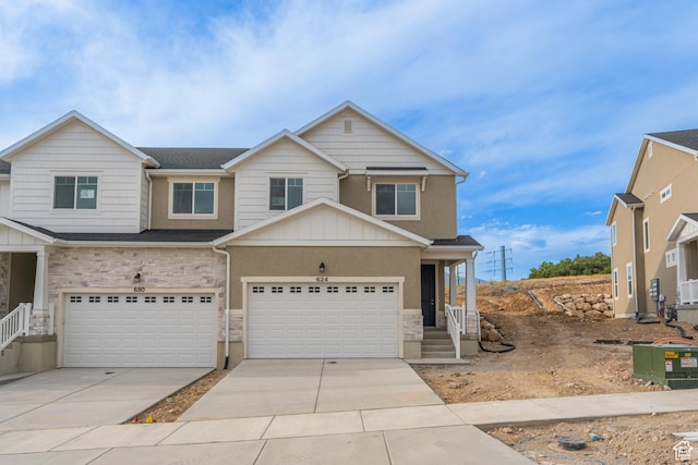 624 W 4500 S Unit 325, Mapleton, UT 84664 - view of front of property featuring stone siding, driveway, a garage, and board and batten siding