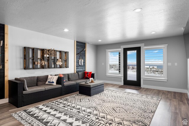 3278 S Serviceberry Dr Unit 18, Garden City, UT 84028 - living room featuring a textured ceiling, wood finished floors, baseboards, and recessed lighting