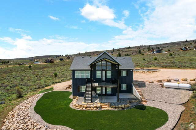 3278 S Serviceberry Dr Unit 18, Garden City, UT 84028 - view of front of property featuring stairs, board and batten siding, a patio, and a front yard