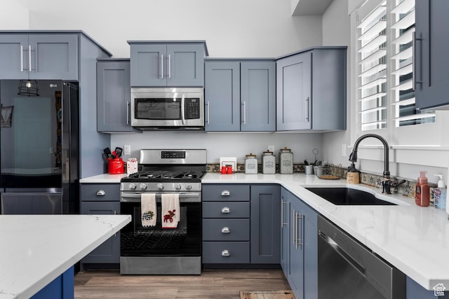 3278 S Serviceberry Dr Unit 18, Garden City, UT 84028 - kitchen with appliances with stainless steel finishes, a sink, plenty of natural light, and wood finished floors