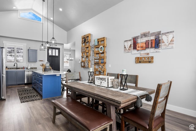 3278 S Serviceberry Dr Unit 18, Garden City, UT 84028 - dining area with high vaulted ceiling, dark wood-style floors, baseboards, and a chandelier