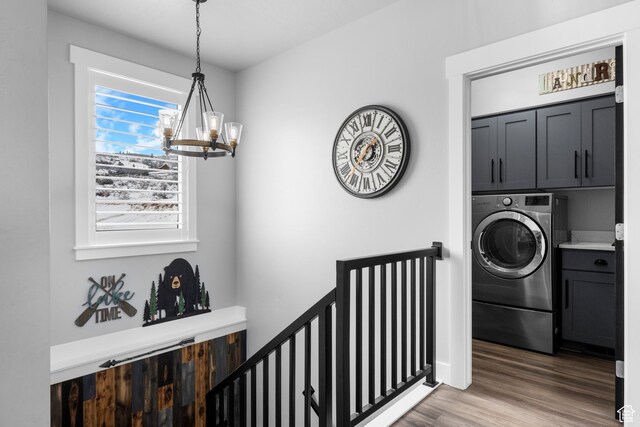 3278 S Serviceberry Dr Unit 18, Garden City, UT 84028 - washroom featuring cabinet space, washer / clothes dryer, a chandelier, and light wood-type flooring