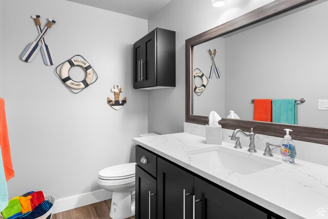 3278 S Serviceberry Dr Unit 18, Garden City, UT 84028 - half bath with wood finished floors, vanity, toilet, and baseboards
