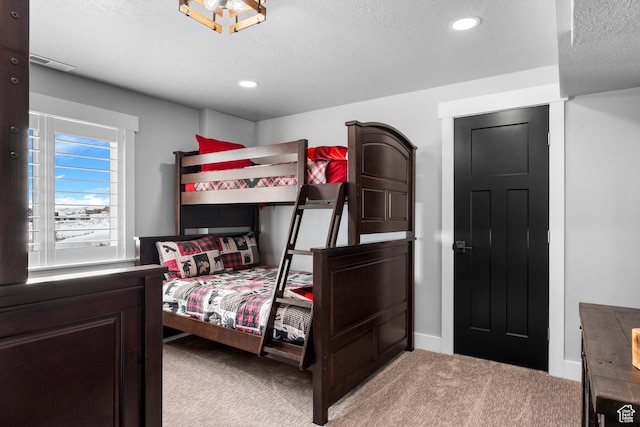 3278 S Serviceberry Dr Unit 18, Garden City, UT 84028 - bedroom with light carpet, a textured ceiling, recessed lighting, and baseboards