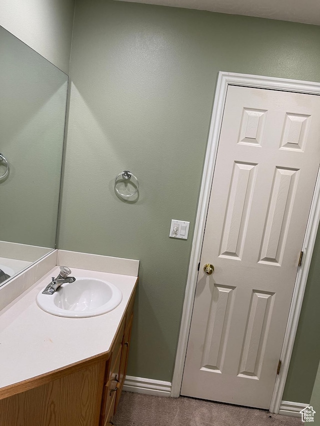bathroom with vanity and baseboards