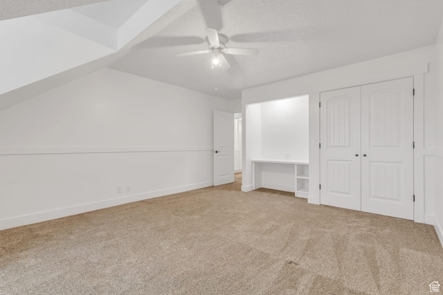 unfurnished bedroom featuring baseboards, a ceiling fan, a closet, and carpet