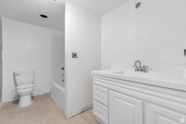 bathroom with baseboards, toilet, vanity,  shower combination, and tile patterned flooring