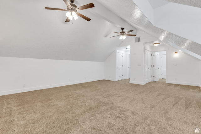 additional living space with vaulted ceiling with beams, a ceiling fan, visible vents, light carpet, and baseboards