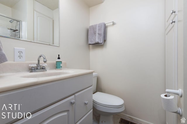 bathroom with a shower with door, visible vents, baseboards, toilet, and vanity