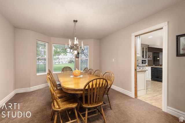dining area featuring a textured ceiling, baseboards, a chandelier, and light carpet