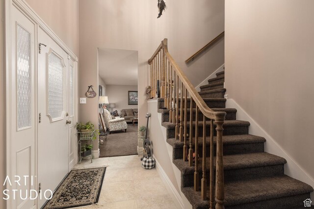 foyer entrance featuring stairs and tile patterned floors