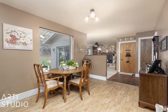 dining area featuring wood finished floors, baseboards, and ceiling fan
