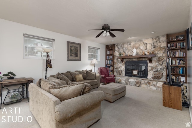 living room featuring a wealth of natural light, a fireplace, carpet floors, and ceiling fan