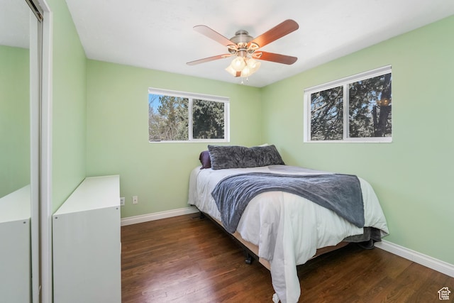 bedroom featuring a ceiling fan, baseboards, and wood finished floors