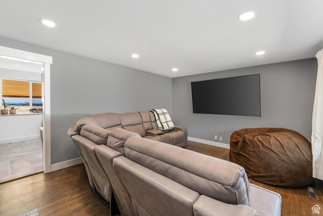 living area featuring recessed lighting, baseboards, and dark wood-style flooring