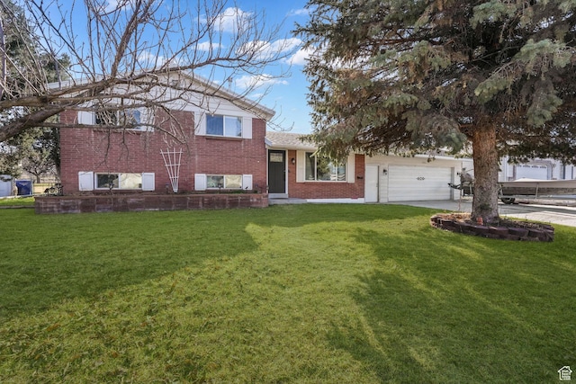 tri-level home featuring brick siding, a garage, concrete driveway, and a front yard