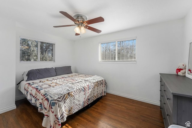 bedroom featuring ceiling fan, baseboards, and wood finished floors
