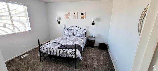 carpeted bedroom with visible vents and baseboards