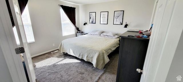 carpeted bedroom with visible vents and baseboards