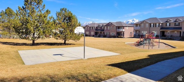 exterior space with a residential view, community basketball court, playground community, and a yard