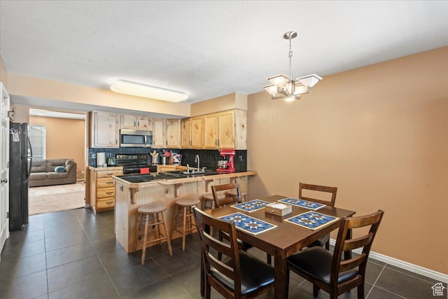 1322 E 6175 S, South Ogden, UT 84405 - kitchen with electric range, light brown cabinetry, stainless steel microwave, backsplash, and a peninsula