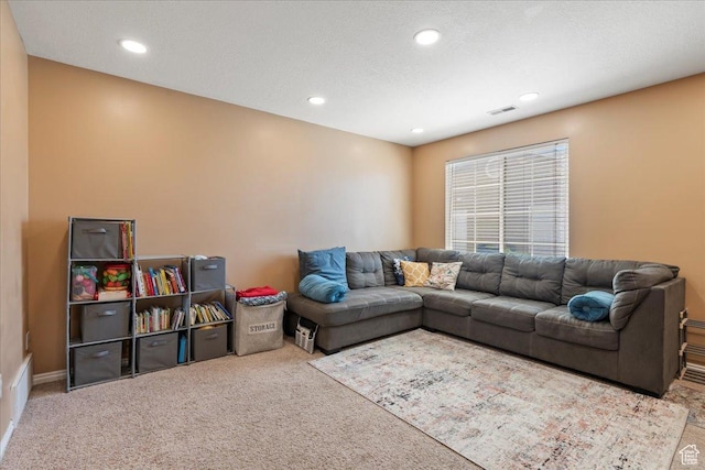 carpeted living area featuring visible vents, recessed lighting, and a textured ceiling