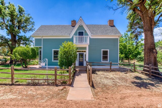 197 N 200 W, Kanab, UT 84741 - victorian-style house with a shingled roof, a balcony, fence, and a chimney