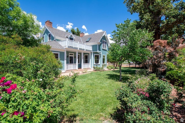 197 N 200 W, Kanab, UT 84741 - rear view of property featuring a balcony, a lawn, covered porch, and a chimney