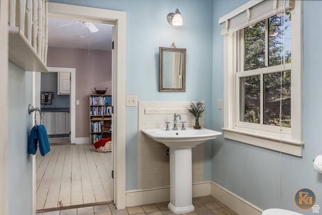 197 N 200 W, Kanab, UT 84741 - bathroom with tile patterned floors, tile walls, ceiling fan, and a sink
