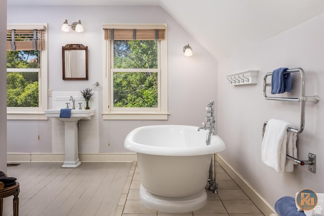197 N 200 W, Kanab, UT 84741 - full bathroom featuring vaulted ceiling, a healthy amount of sunlight, baseboards, and a freestanding bath